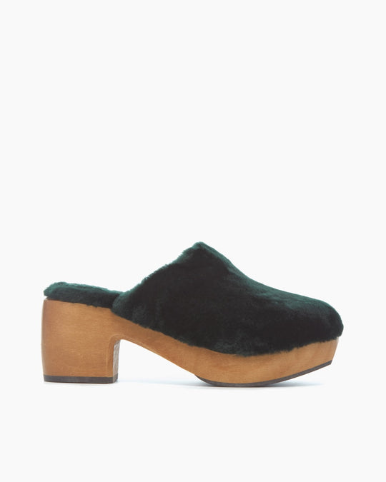 A Hunter Green Shearling clog with a wooden platform heel and a rounded toe.